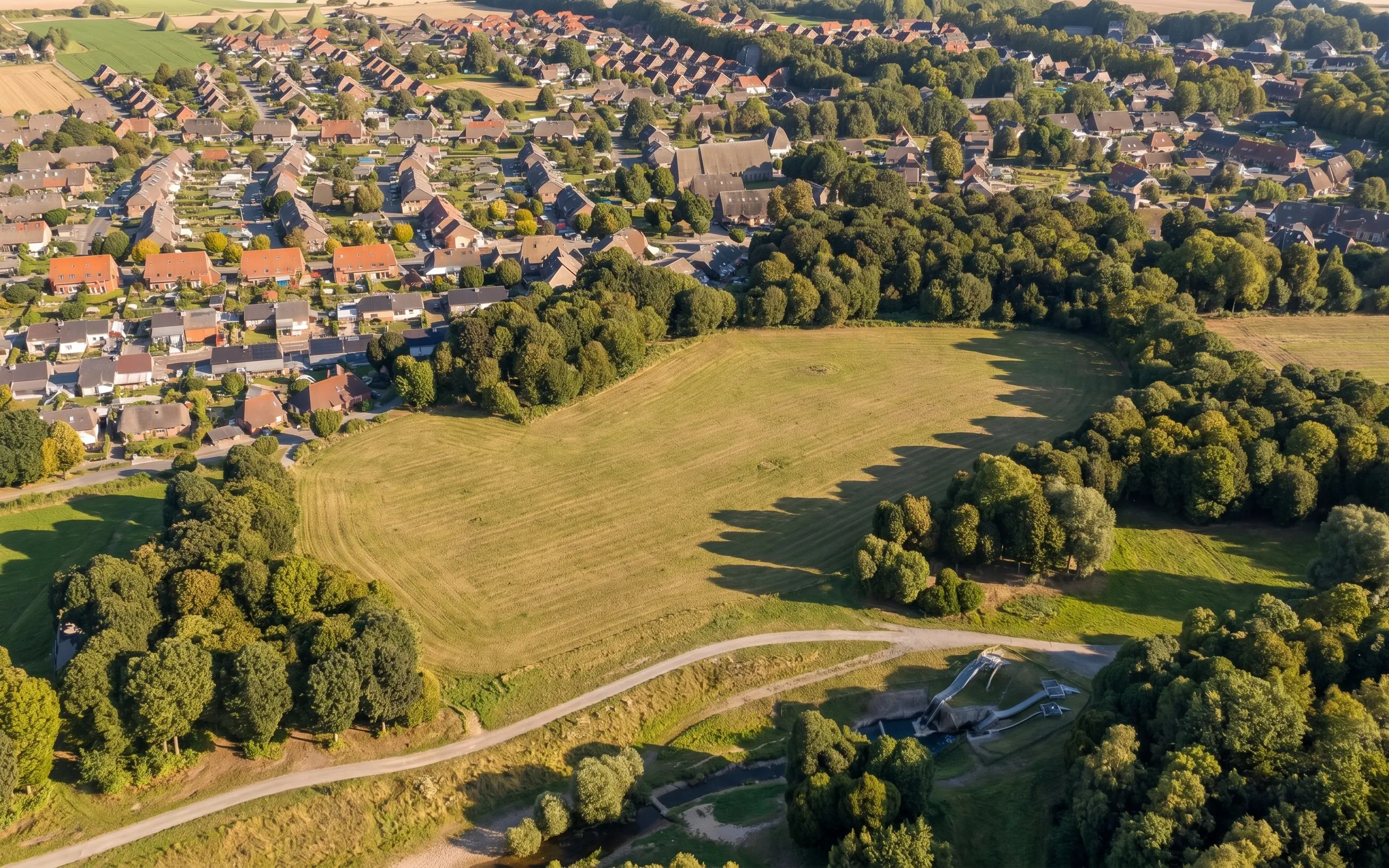 The studio opens on the open farmland at Marl, North Rhine-Westphalia, the eight nearest homes visible around the field.